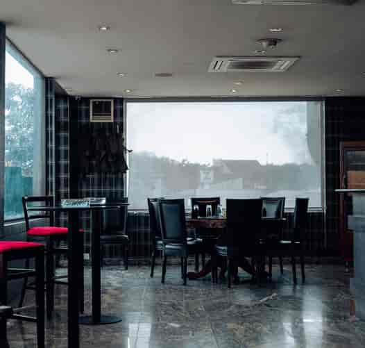 Noir Lagos dining nook with mismatched seating for professional event venue hire.