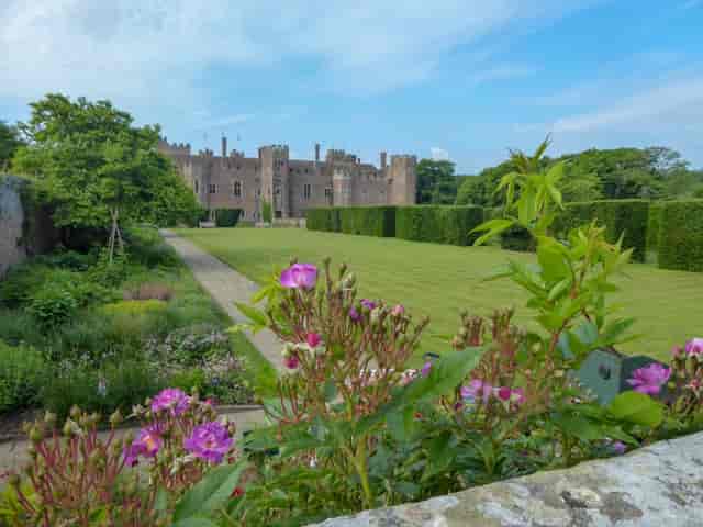 Herstmonceux Castle courtyard with manicured lawns for luxury weddings and corporate retreats.