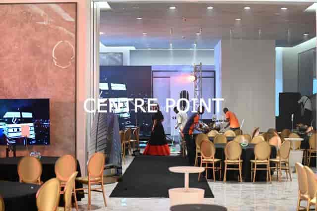 Event hall load-in at Centre Point with stage rehearsal for corporate event planning.