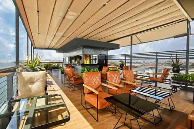 Cowries Creek rooftop venue with lounge seating for luxury cocktail hours and networking events.