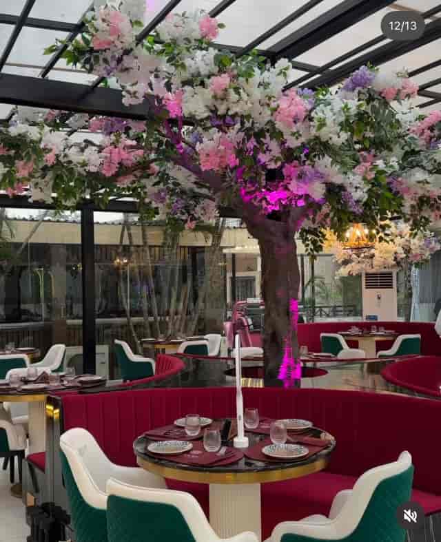 Euphoria restaurant venue with floral tree and velvet seating for upscale evening events.