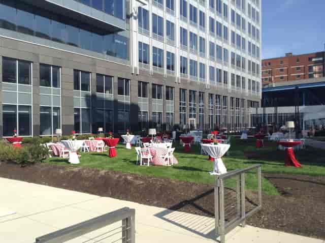 The Veranda outdoor space, networking reception with high-top tables, corporate event venue.
