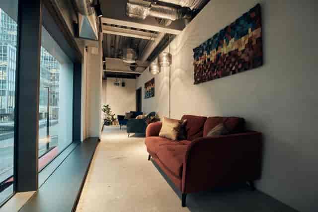Modern Table Top Podcast Room with plush seating for pre-event networking and meetings.