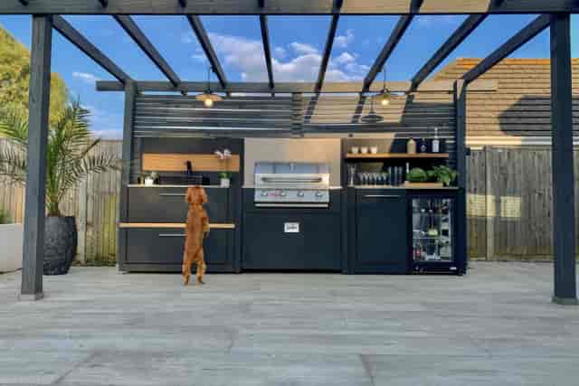 Outdoor kitchen for high-end networking event with ambient lighting and professional catering.