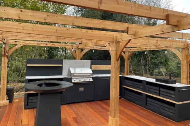 Outdoor kitchen with premium grill for high-end networking events and corporate team-building.