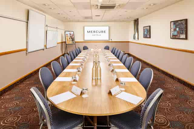Boardroom setup in The Broker Suite, Mercure Glasgow City for team meetings and strategic workshops.