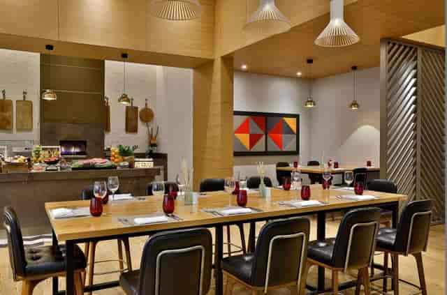 Baiterek F&B space at Sheraton Astana with modern wood decor for corporate meetings and events.