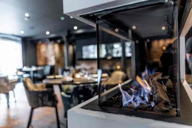 The Kitchin restaurant interior with ambient fireplace lighting for VIP dinners and events.