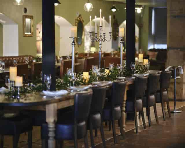 Rustic banquet setup at Season Quayside with wooden tables for upscale events and networking.