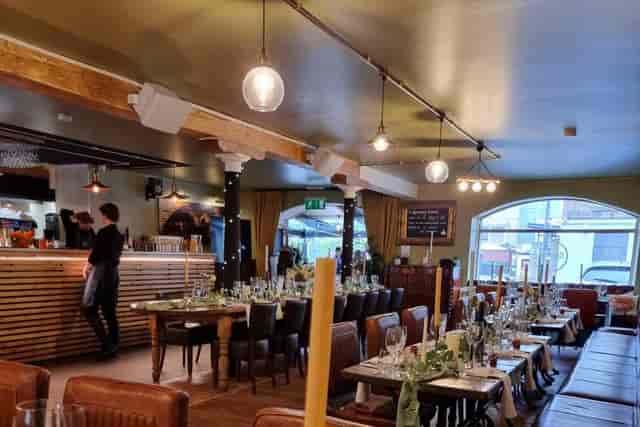Rustic-chic event space at Season Quayside with banquet tables for private dining and rehearsal.