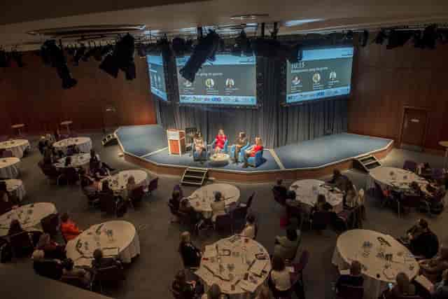 Tausend Room conference setup with multi-screen stage for professional plenary event planning.