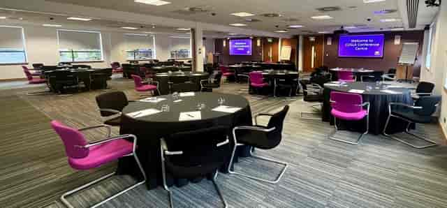 COSLA Conference Centre catering space with modern round tables for workshops and events.