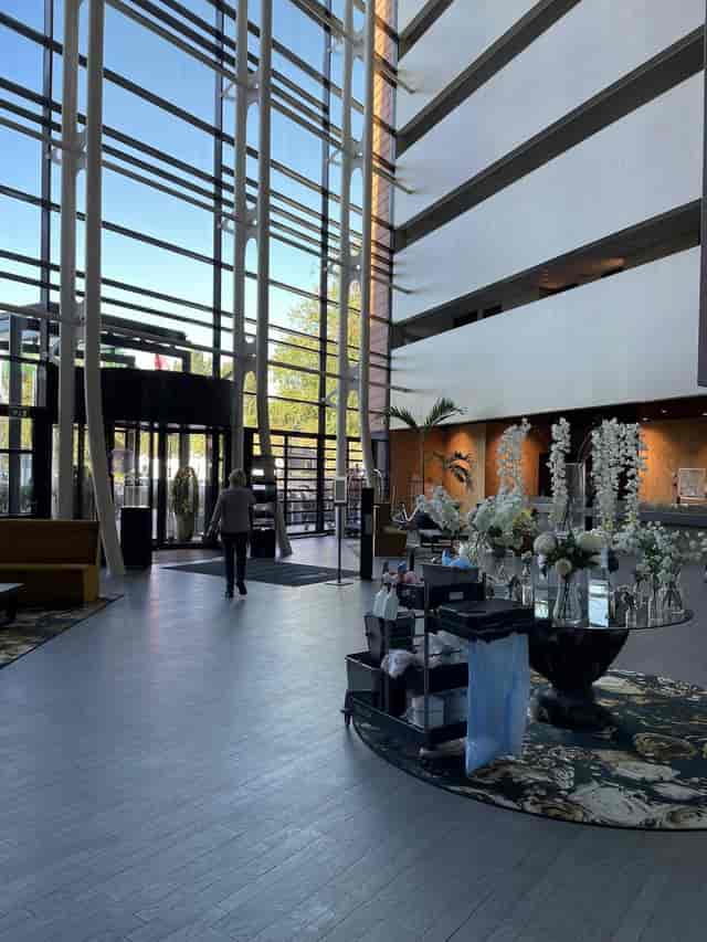 Modern hotel foyer with high ceilings, ideal for event registration and corporate breakout spaces.