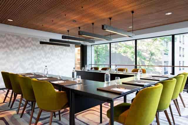 Modern U-shape boardroom with lime seating for executive meetings and corporate workshops.