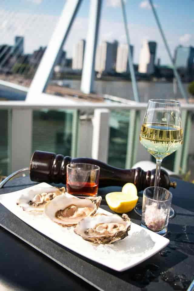 Rooftop terrace networking event in nhow Rotterdam with white wine and fresh oysters.