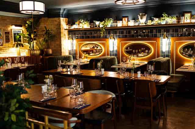 Elegant private dining at Elaine’s London with velvet banquettes for upscale event hosting.