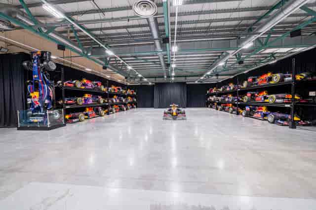 MK-7 Warehouse at Red Bull Racing, modern event space with Formula 1 cars for corporate gatherings.