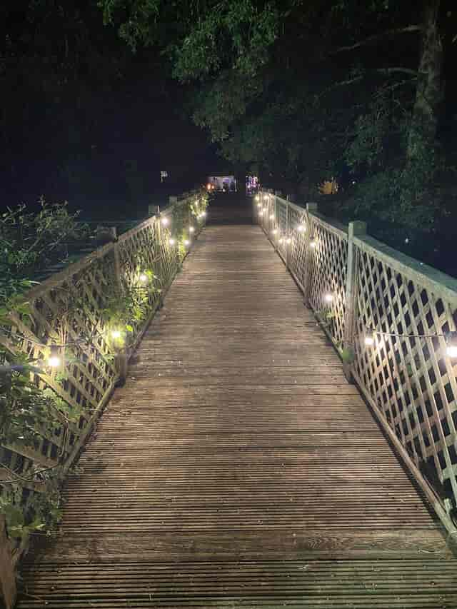 Lodge Tents at Kenton Hall Estate featuring atmospheric bistro lighting for rustic wedding events.