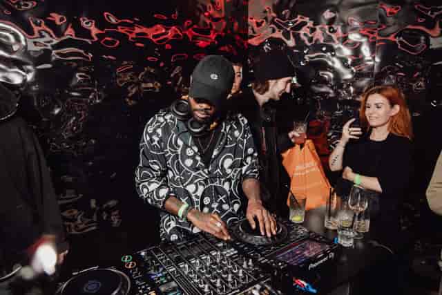 DJ at Qube Elephant Lounge, vibrant event atmosphere, entertainment networking.