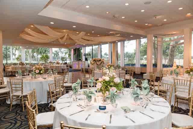Elegant Jacaranda Club wedding reception with gold Chiavari chairs and scenic golf course views.