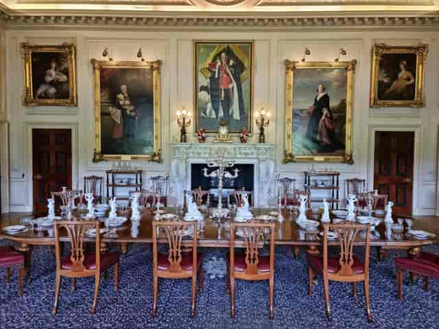 Formal board meeting or gala dinner at historic Harewood House Courtyard with period furniture.