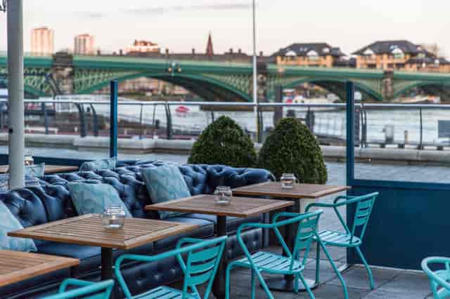Riverside Terrace outdoor venue with bridge view for corporate networking and team-building events.