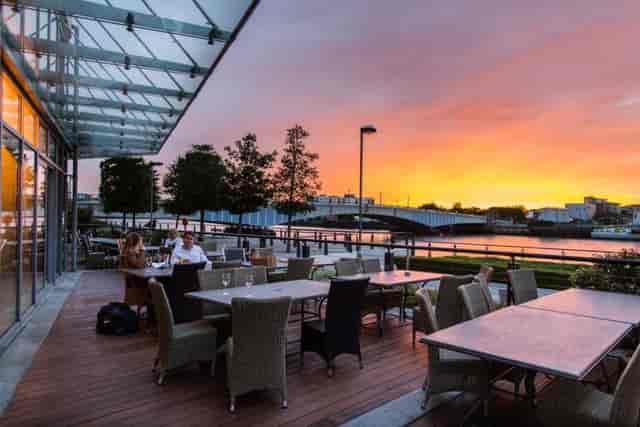 Riverside Terrace sunset waterfront view: outdoor networking event and premium dinner venue.