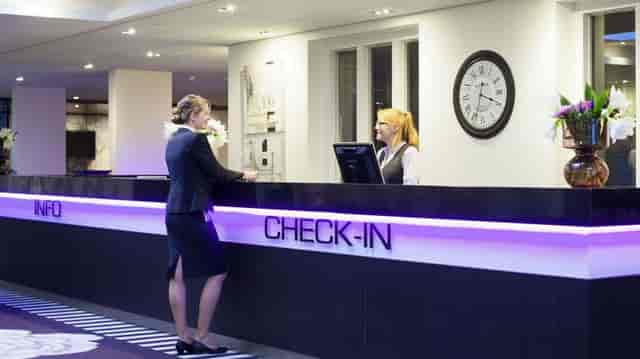 Professional hotel lobby check-in desk for event registration and delegate arrival.