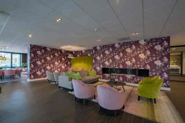 Modern hotel lobby with lounge seating and fireplace for networking and small-group meetings.