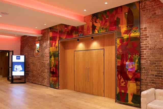 "Banqueting Hall in Glaziers Hall: modern event space with exposed brick, perfect for gatherings"