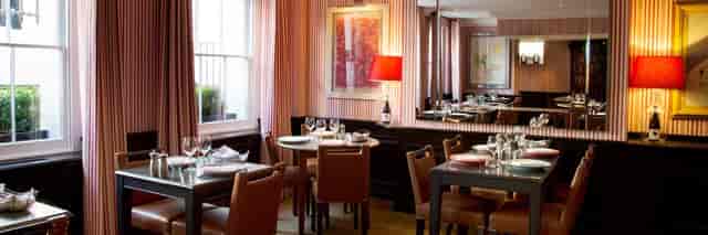 Sophisticated restaurant dining space with elegant decor for intimate meetings and events.
