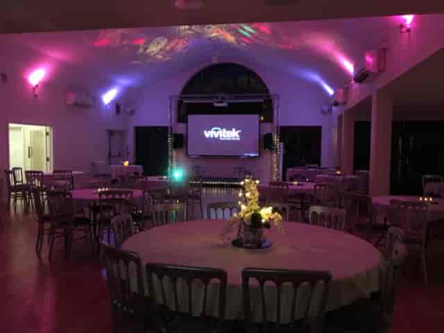 Bennets Club card room with banquet seating and stage lighting for corporate or social events.