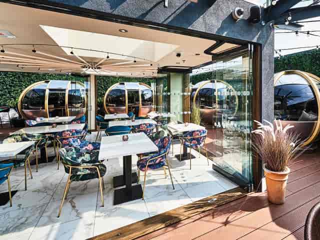 Cocktail bar at Secret Garden with dining pods for high-end networking events and private mixers.