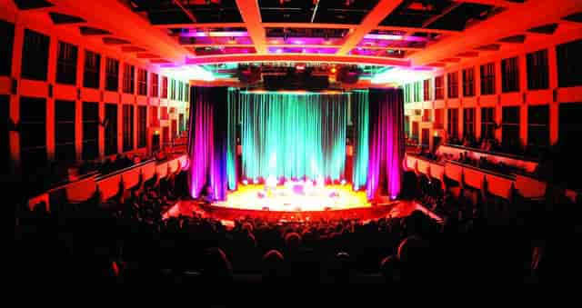 ArtPlay theater stage setup with dynamic LED lighting for corporate general session event.