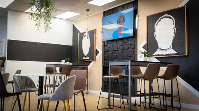 Modern breakout room at POLARIS BHM with high-top seating for hybrid meetings and networking.