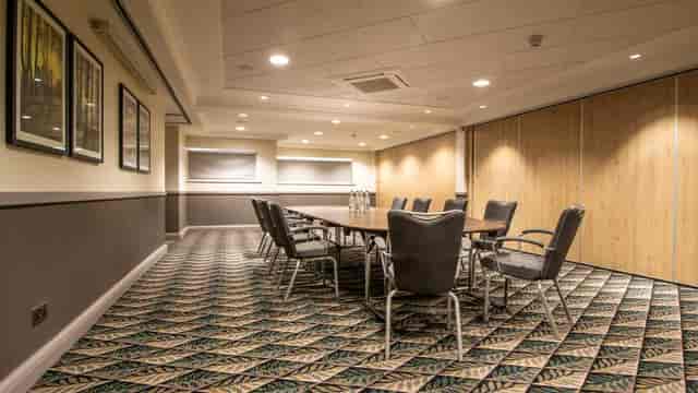 Boardroom-style function room with patterned carpet for corporate meetings and strategy sessions.