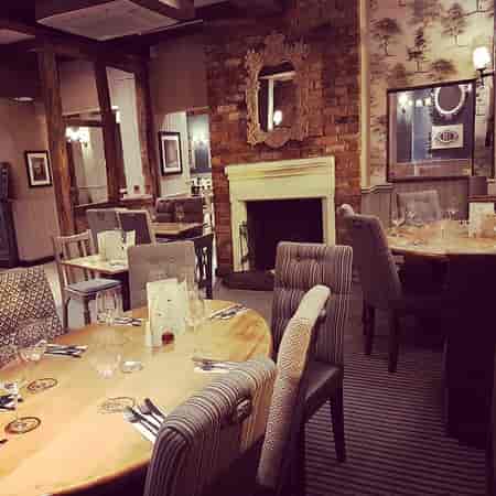 Rustic Garden House restaurant with fireplace, ideal for networking dinners and breakout sessions.