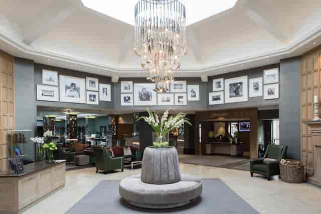 Elegant hotel bar with floral arrangement, perfect for sophisticated events and gatherings.