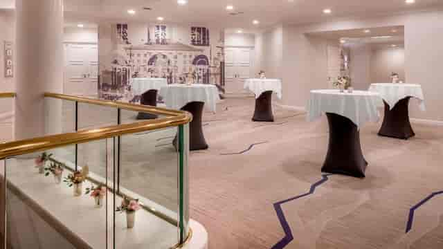 Munich Marriott hotel meeting room with high-top tables for professional networking events.