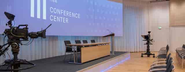 Hybrid conference stage with panel table at HBW ConferenceCenter for professional events.