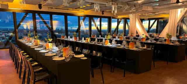 Upside East rooftop gala with sleek tables and city views for corporate events and networking.