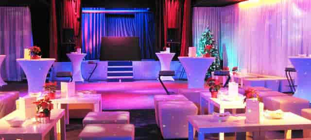 Oberangertheater corporate holiday event with lounge seating and ambient LED stage lighting.