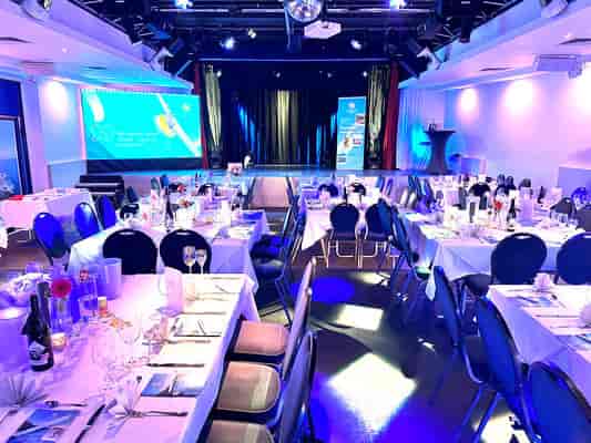 Oberangertheater gala dinner event space with stage and banquet seating.