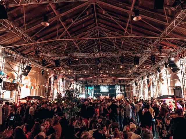 Utopia industrial function room with overhead rigging for networking events and festivals.