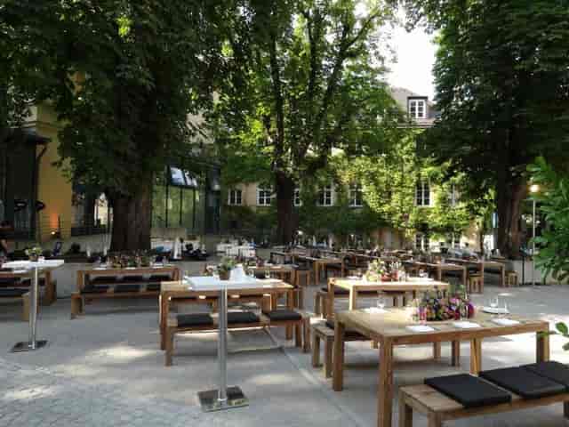 Root Cellar Praterinsel courtyard venue with wooden benches for rustic receptions and events.