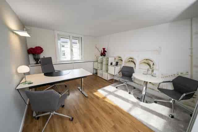 Executive breakout room with round table for private meetings and hybrid collaboration.