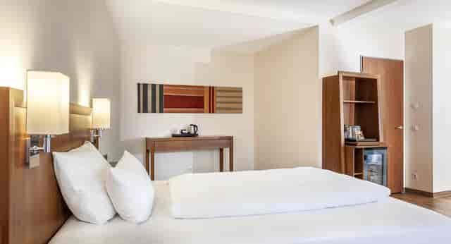 Minimalist hotel room at feel@ease Bar for corporate meetings and business travel.