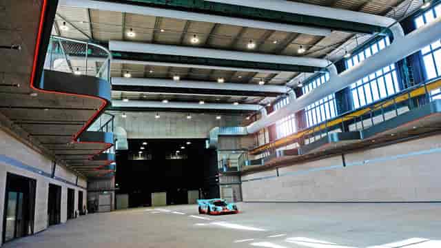 Industrial Kleine Lokhalle event space in Motorworld München for automotive showcases.