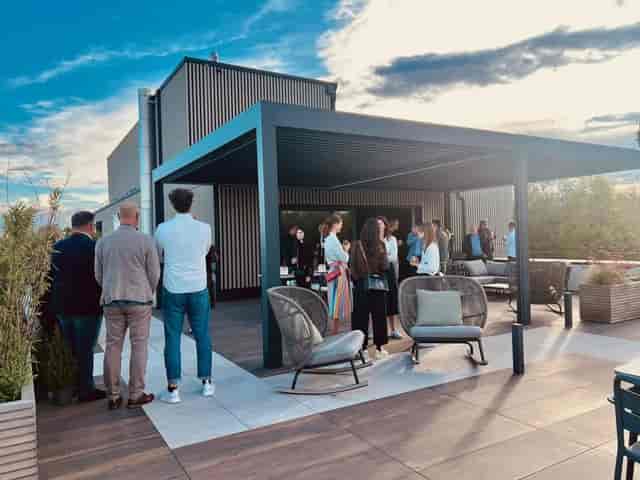Corporate team networking reception on a high-end rooftop lounge for outdoor business events.