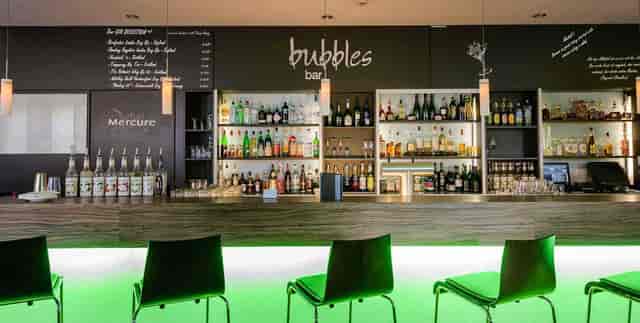 Modern hotel lobby bar with neon lighting for corporate events and networking receptions.